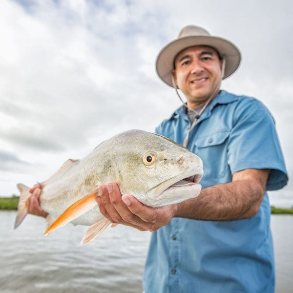 Man holding huge redfish